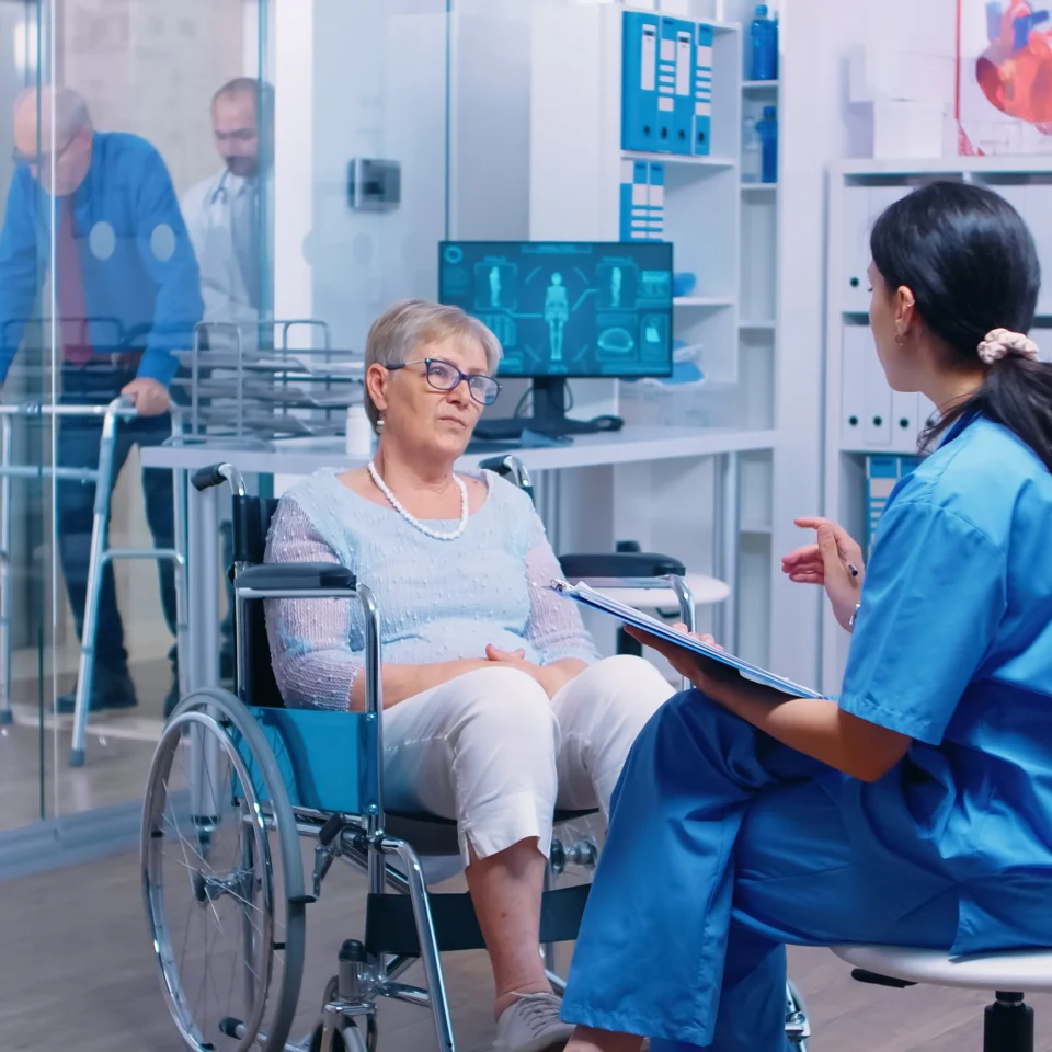 nurse-talking-with-senior-woman-with-walking-disabilities-sitting-wheelchair-into-private-modern-recovery-clinic-hospital-handicapped-old-retired-patient-medical-consultation-advice